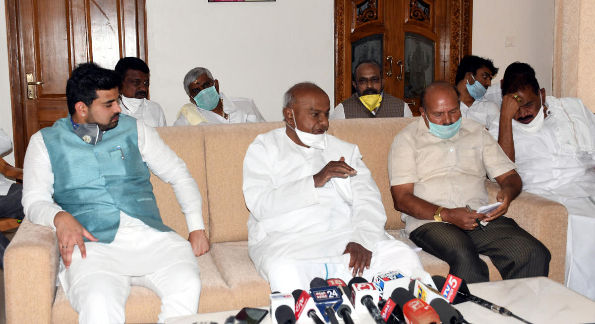 Former prime minister H D Deve Gowda with MP Prajwal Revanna in Hassan on Monday. DH PHOTO