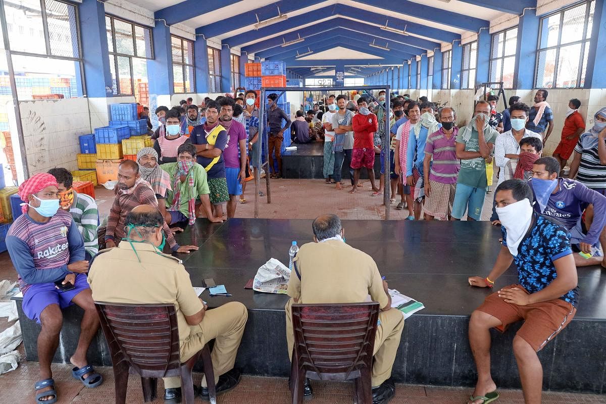 Police distribute ID cards to stranded migrant labours during the nationwide lockdown, imposed in wake of the coronavirus outbreak, at Beypore harbour in Kozhikode, Thursday, April 16, 2020. (PTI Photo) 