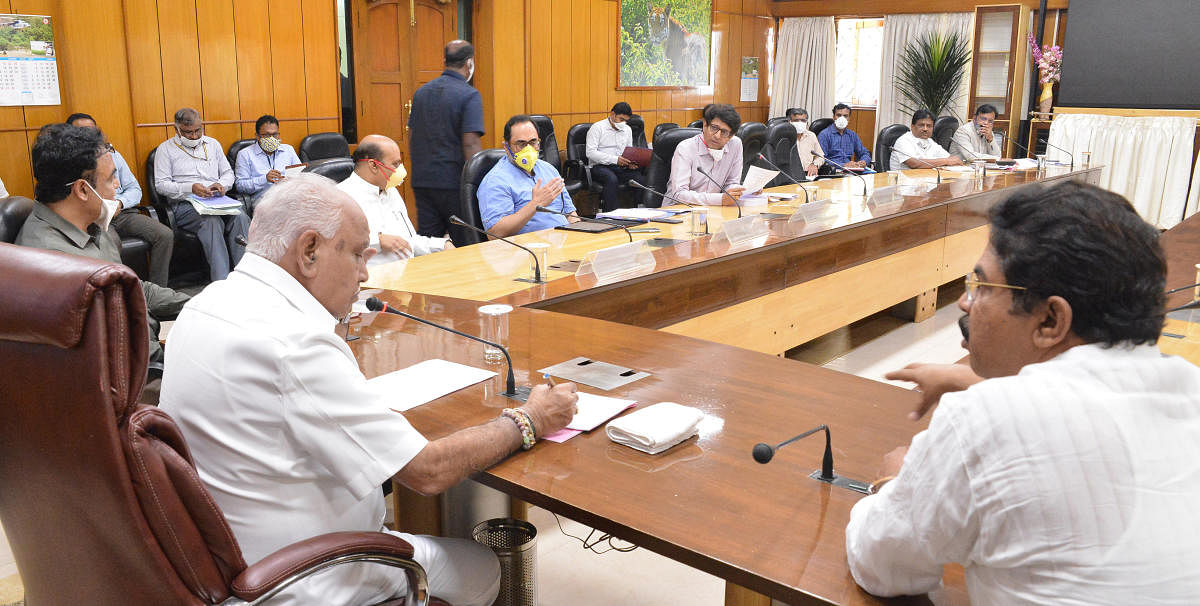 Chief Minister B S Yediyurappa chairs a meeting to review the Akrama-Sakrama scheme in Bengaluru on Friday.
