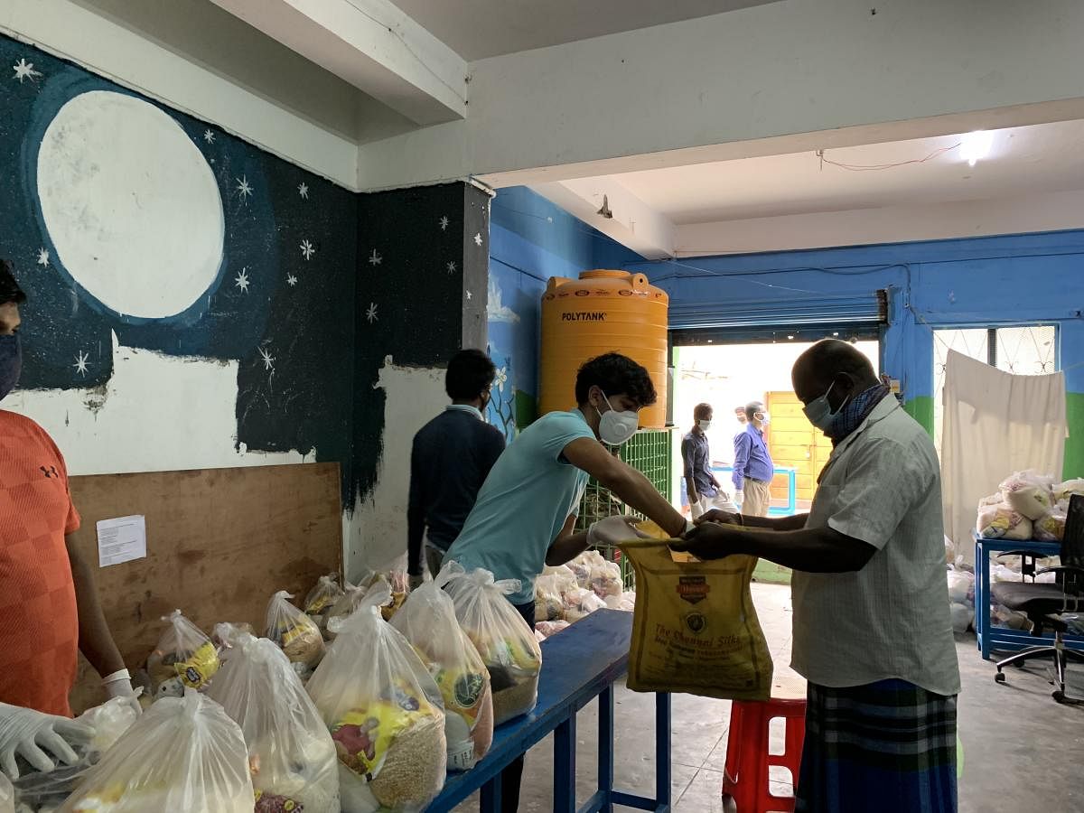 Volunteers distribute grocery to residents of slums in Bengaluru.