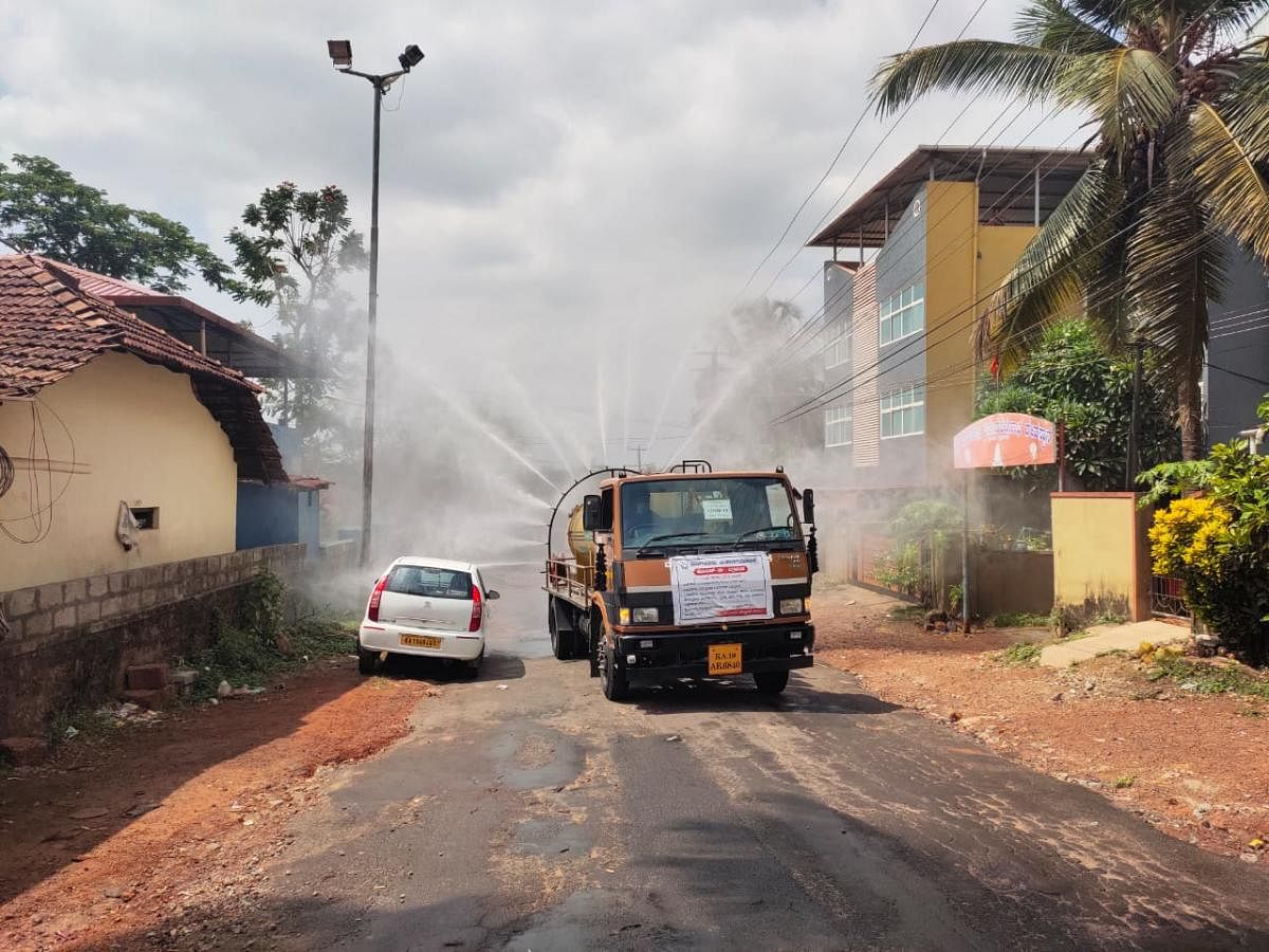 Disinfectant sprayed at Shakthinagara on Tuesday after a mother and son tested positive for Covid-19.