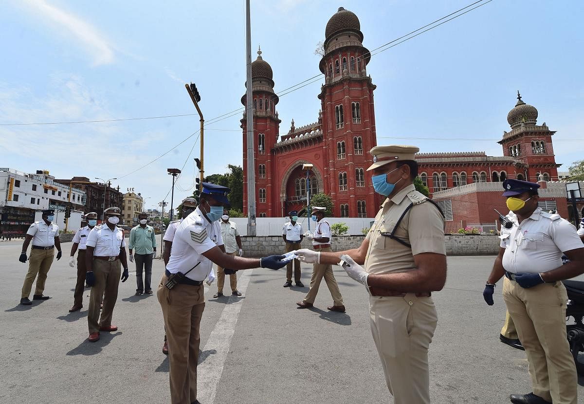 Assistant Commissioner of Police (ACP), Traffic, Ravichandran distributes vitamin tablets to his colleagues in a bid to improve immunity against COVID-19 outbreak during the nationwide lockdown, in Chennai. (PTI Photo)