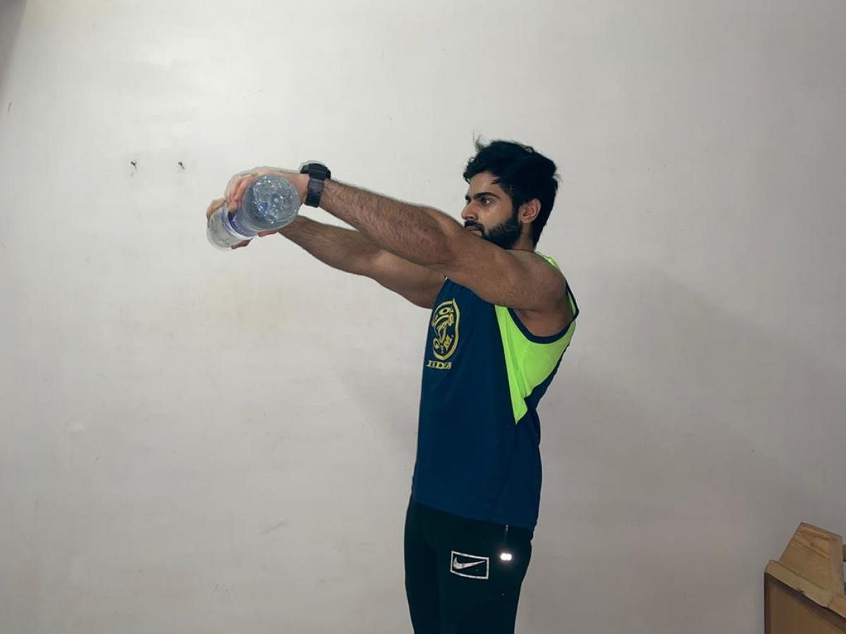 Use household items such as water bottles if you don't have access to weights. In picture: Hitesh Chhabria.