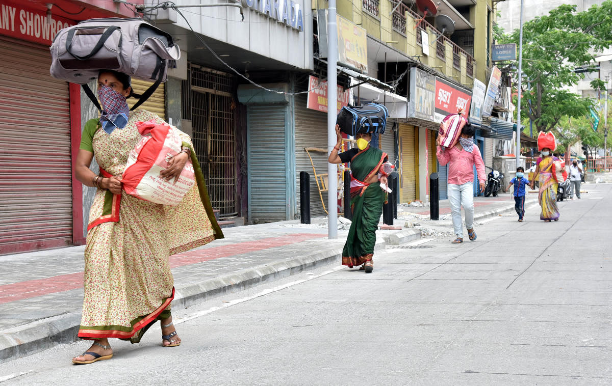 Migrant workers and their family carrying luggage and walks through KSRTC bus stop during lockdown in Bengaluru on Saturday, May 02, 2020. Photo by Janardhan B K