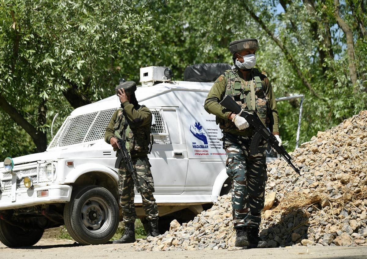 Security forces stand guard during an encounter with militants, at Beighpora area in Pulwama district of South Kashmir, Wednesday, May 6, 2020. Commander-in-Chief of Hizbul Mujahideen Riyaz Naikoo and three other militants were killed in two different operations by security forces. (PTI Photo)