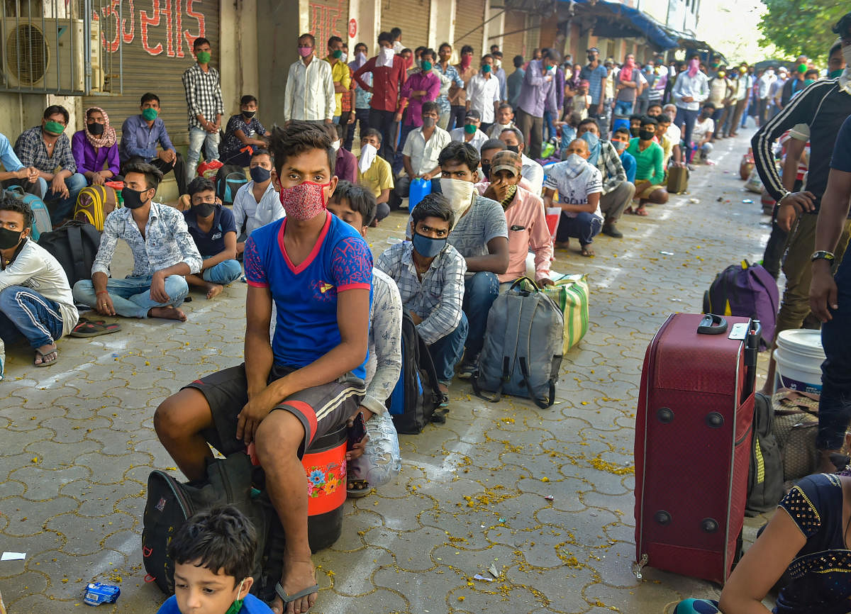 Thane: Migrants from the northern states wait for a train to travel to their native places, during the COVID-19 nationwide lockdown, at Bhiwandi in Thane district, Wednesday, May 6, 2020. (PTI Photo/Mitesh Bhuvad)(PTI06-05-2020_000168B)