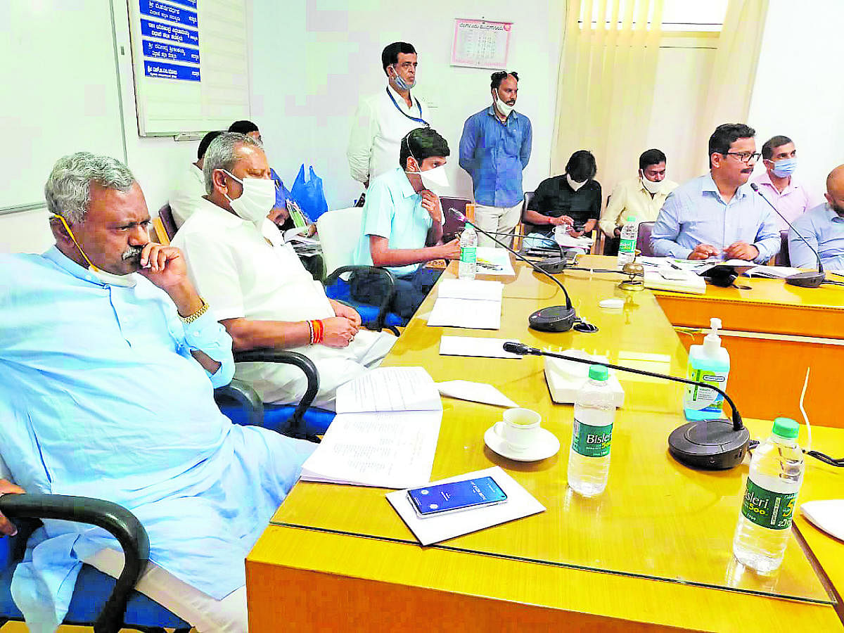 District In-charge Minister S T Somashekar and Urban Development Minister B A Basavaraj during a meeting at Mysuru Urban Development Authority office in Mysuru on Thursday. Deputy Commissioner Abhiram G Sankar is seen.