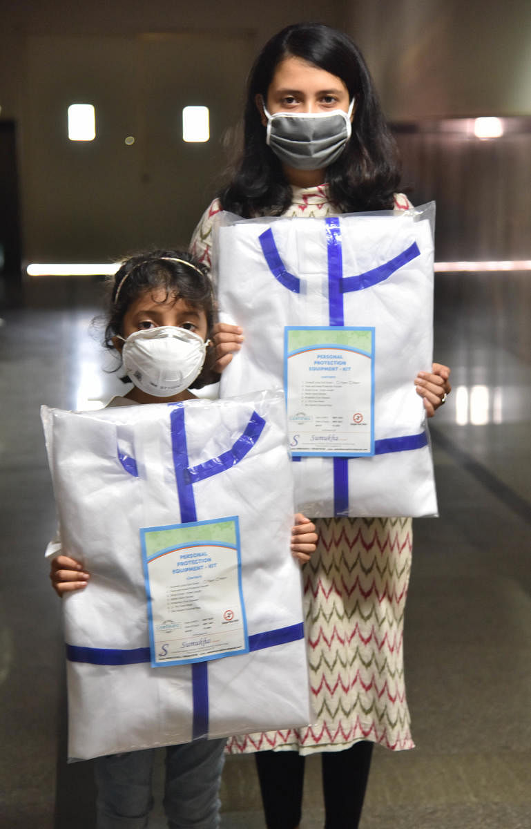 Students Sinchana and Sonia Seth collecting money 45000 rupees and purchased PPE kits, masks and hand gloves for presenting to Victoria Hospital during COVID-19, in Bengaluru on Friday, 15 May, 2020. Photo by Janardhan B K