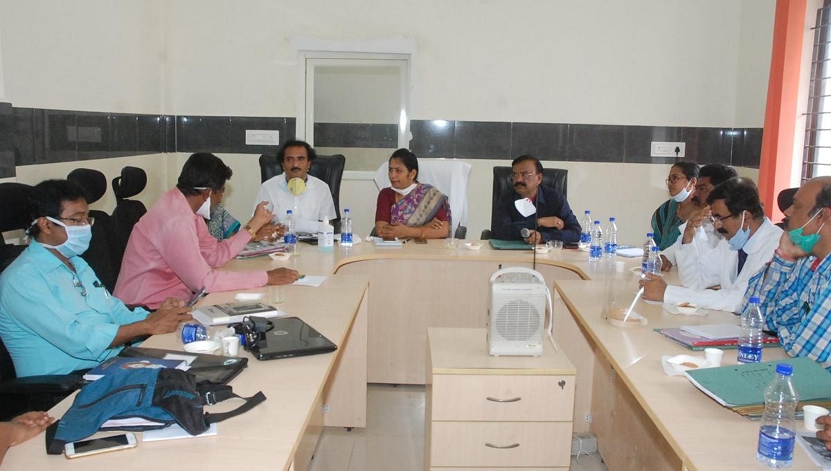 Deputy commissioner C Satyabhama chairs a meeting with the health department officials to relocate Covid-19 patients from R L Jalappa Hospital and Research Centre to the SNR district hospital in Kolar on Saturday.