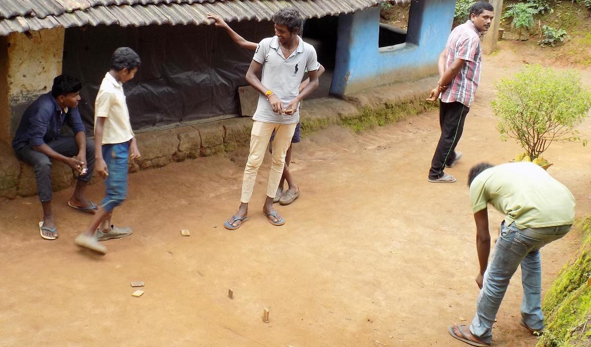 Students of Class 10 in Devarapura tribal hamlet, near Gonikoppa, play games during lockdown. DH Photo