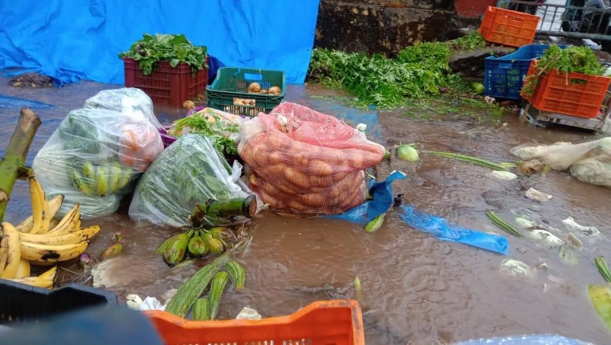 Heavy rains washed away vegetables, caused waterlogging and triggered chaos at APMC market in Baikampady in Mangaluru on Monday morning.