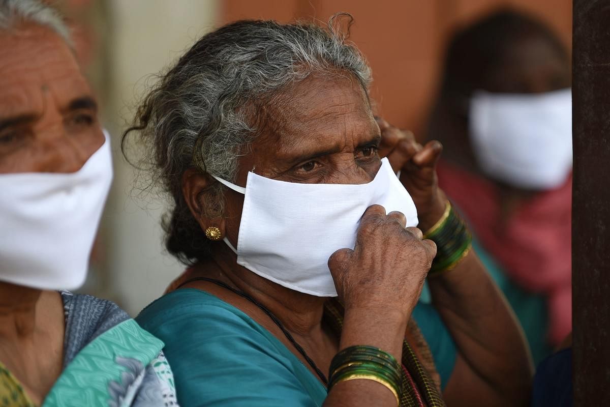Leprosy affected people, wear facemasks being distributed by a non-governmental organisation amid concerns over the spread of the COVID-19 novel coronavirus, at Gandhi Leprosy Seva Sangh, a rehabilitation centre for leprosy patients, in Ahmedabad. (AFP Photo)