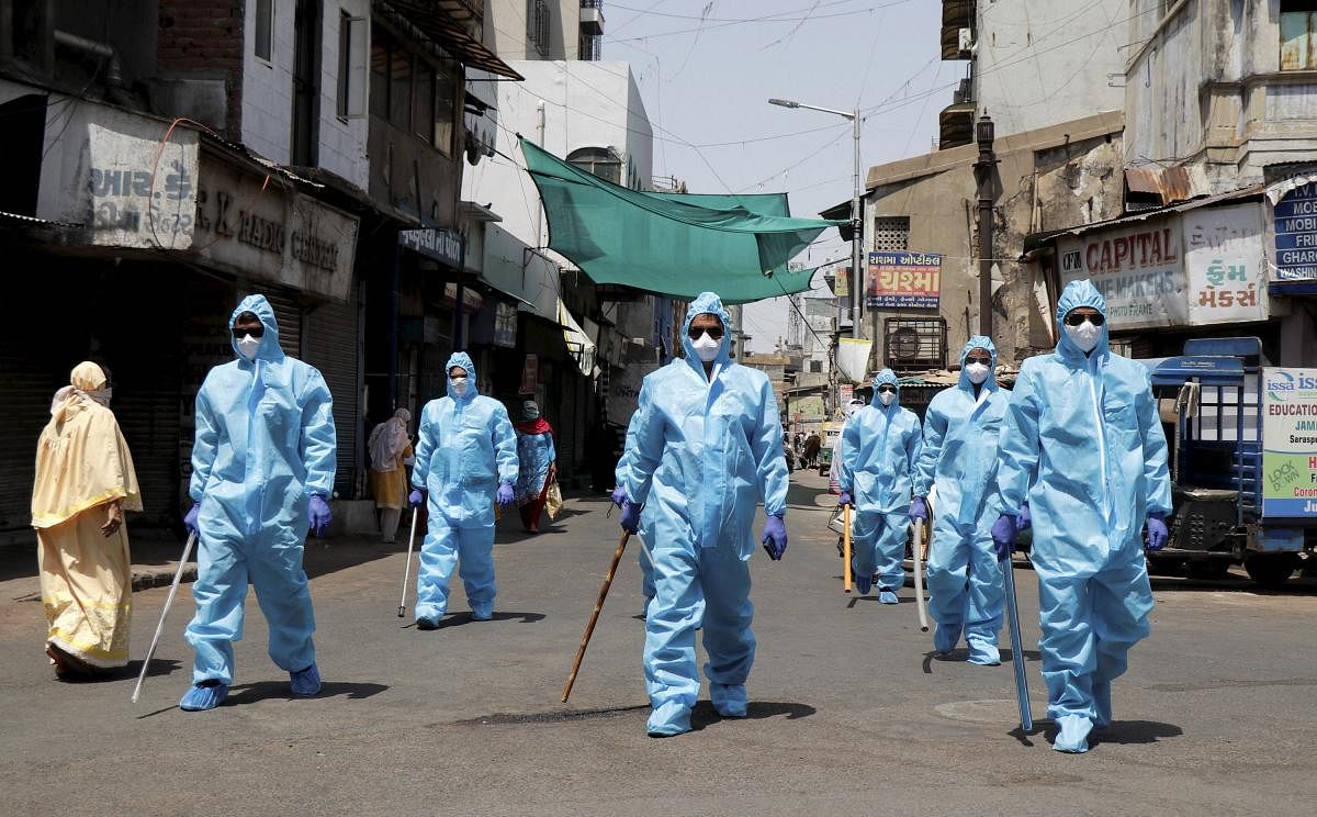 Policemen wearing protective suits patrol a street during the nationwide lockdown (PTI Photo)