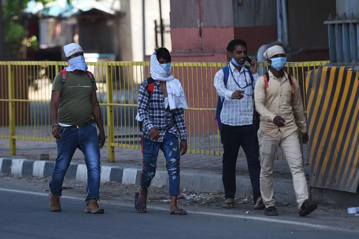 Workers walk on highway towards Uttar Pradesh after government closed transport during the first day of a 21-day government-imposed nationwide lockdown as a preventive measure against the COVID-19 coronavirus, in Faridabad in the state of Haryana on March 25, 2020. Credit: AFP Photo