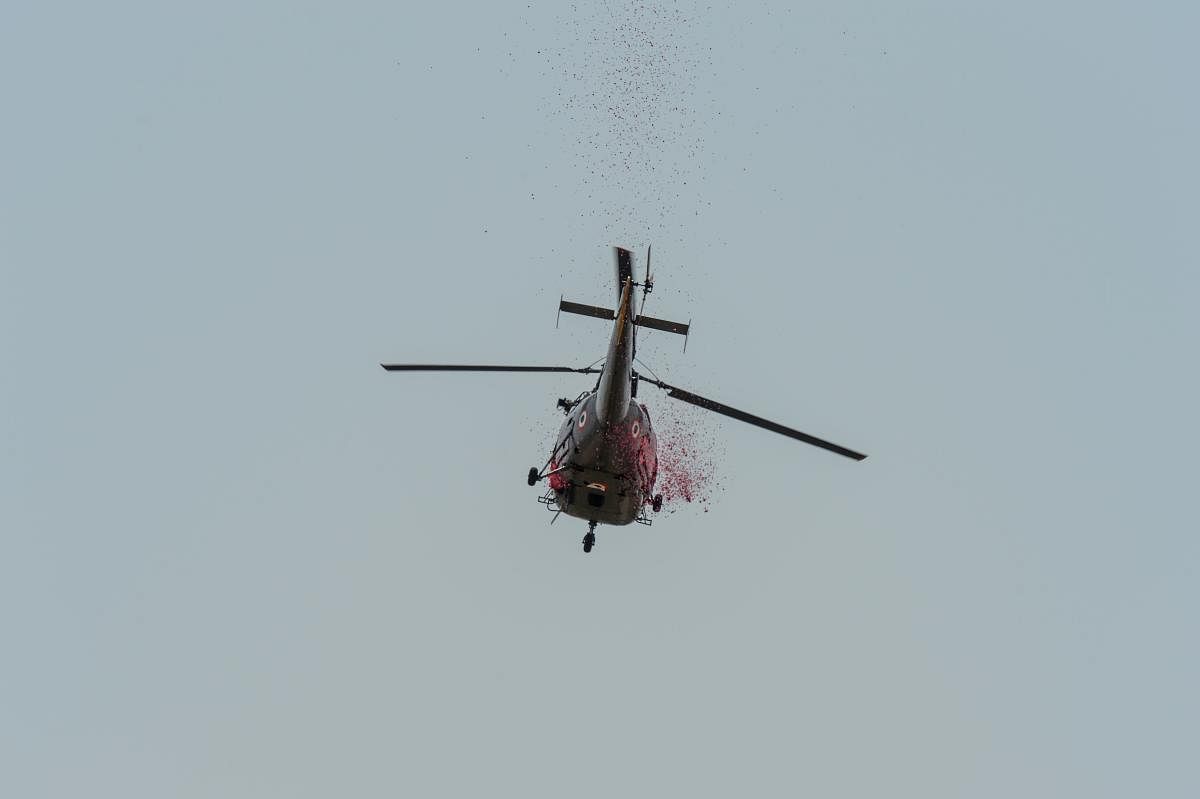 An Indian Air Force (IAF) helicopter throws rose petals from the sky to pay tribute to the medical staff (AFP Photo)