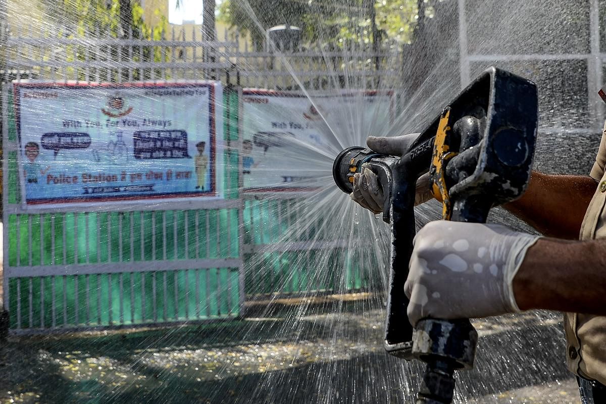  A firefighter disinfects a street near Nizamuddin Markaz Mosque, also known as Banglewali Masjid, during a government-imposed nationwide lockdown as a preventive measure against the COVID-19 coronavirus, in New Delhi on April 2, 2020. Credit: AFP Photo