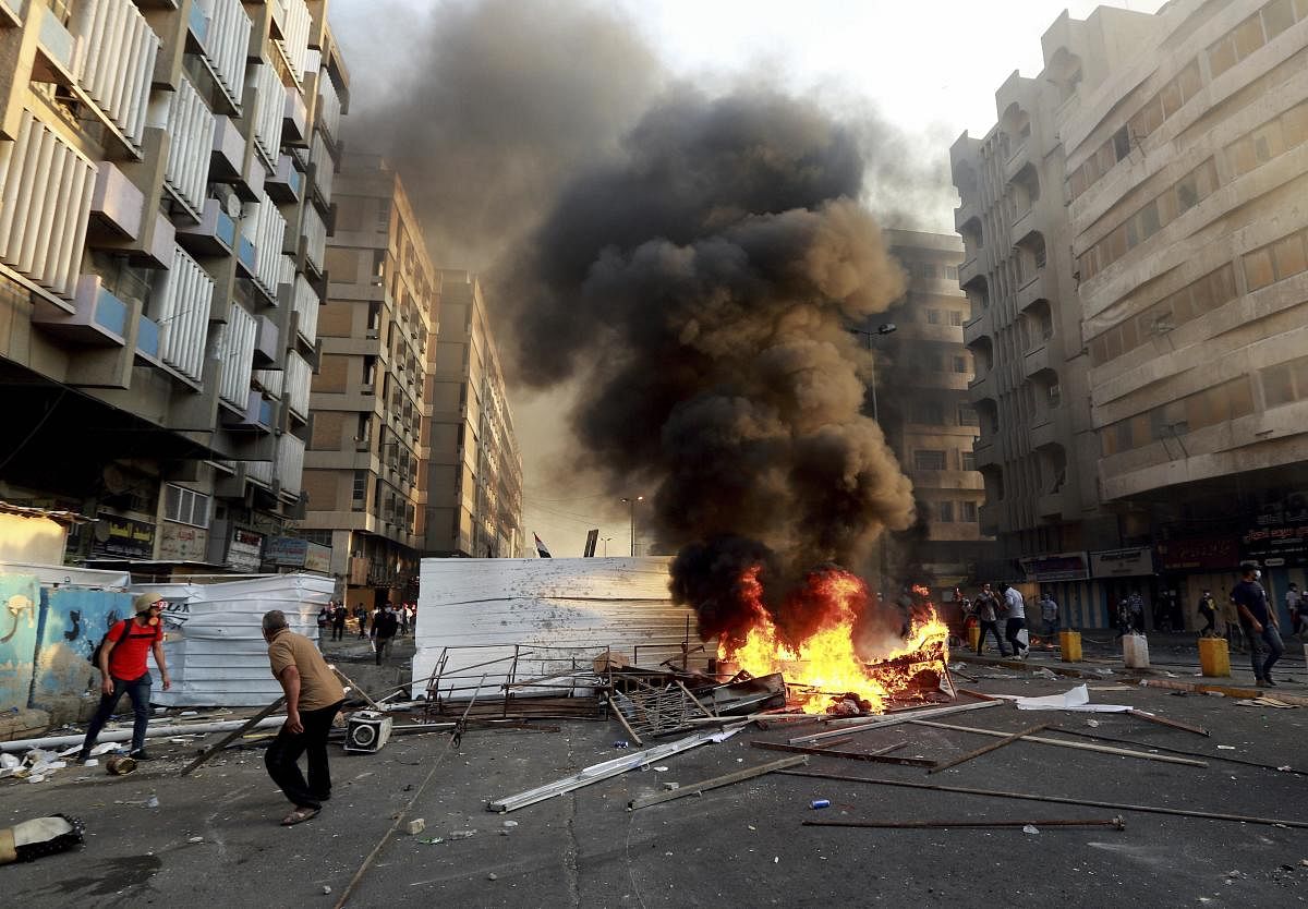 Anti-government protesters set fire and close streets during ongoing protests in Baghdad, Iraq, in central Baghdad, Iraq, Saturday, Nov. 9, 2019. (AP/PTI Photo)