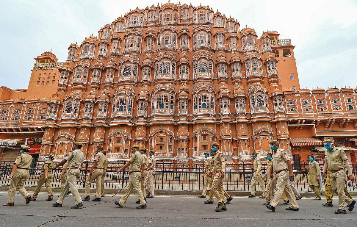 Security personnel patrol a street in front of Hawa Mahal during a nationwide lockdown imposed in the wake of coronavirus pandemic, in Jaipur. (PTI Photo)