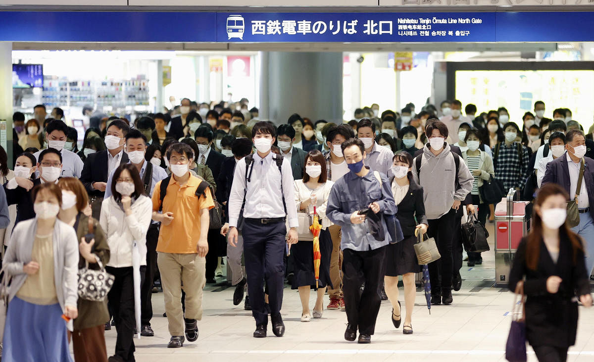 Commuters wearing protective face masks are seen a day after the government announced the lifting of the state of emergency by the coronavirus disease (COVID-19) in large parts of the country in Fukuoka, Japan. Credit: Reuters Photo