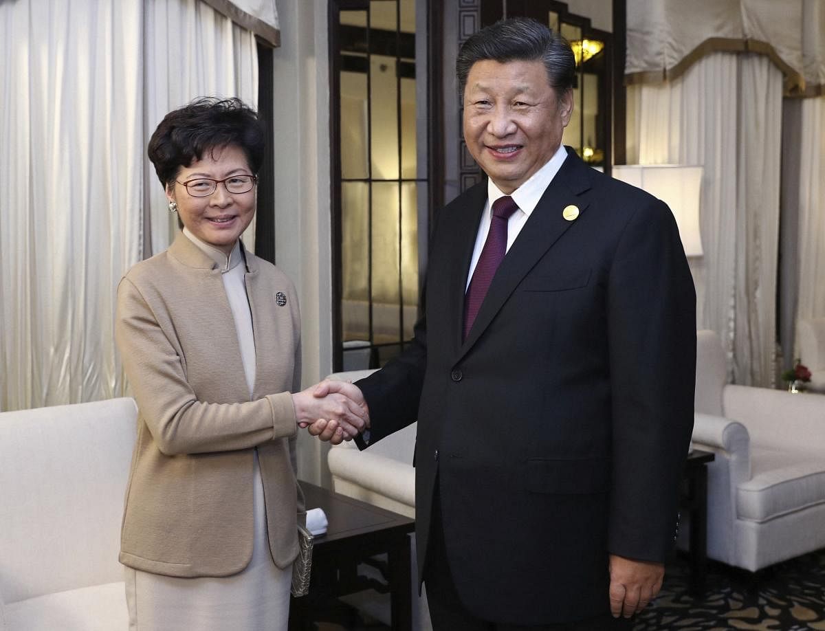 In this Monday, Nov. 4, 2019, photo released by China's Xinhua News Agency, Chinese President Xi Jinping poses with Hong Kong Chief Executive Carrie Lam for a photo during a meeting in Shanghai, China. Lam is here for the second China International Import Expo. AP/PTI
