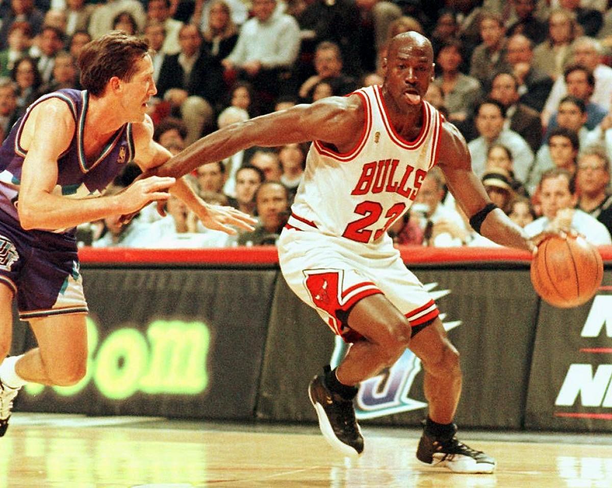  In this file photo taken on June 4, 1997 Chicago Bulls player Michael Jordan sticks out his tongue as he goes past Jeff Hornacek of the Utah Jazz during game two of the NBA Finals at the United Center in Chicago, IL. Credit: AFP Photo