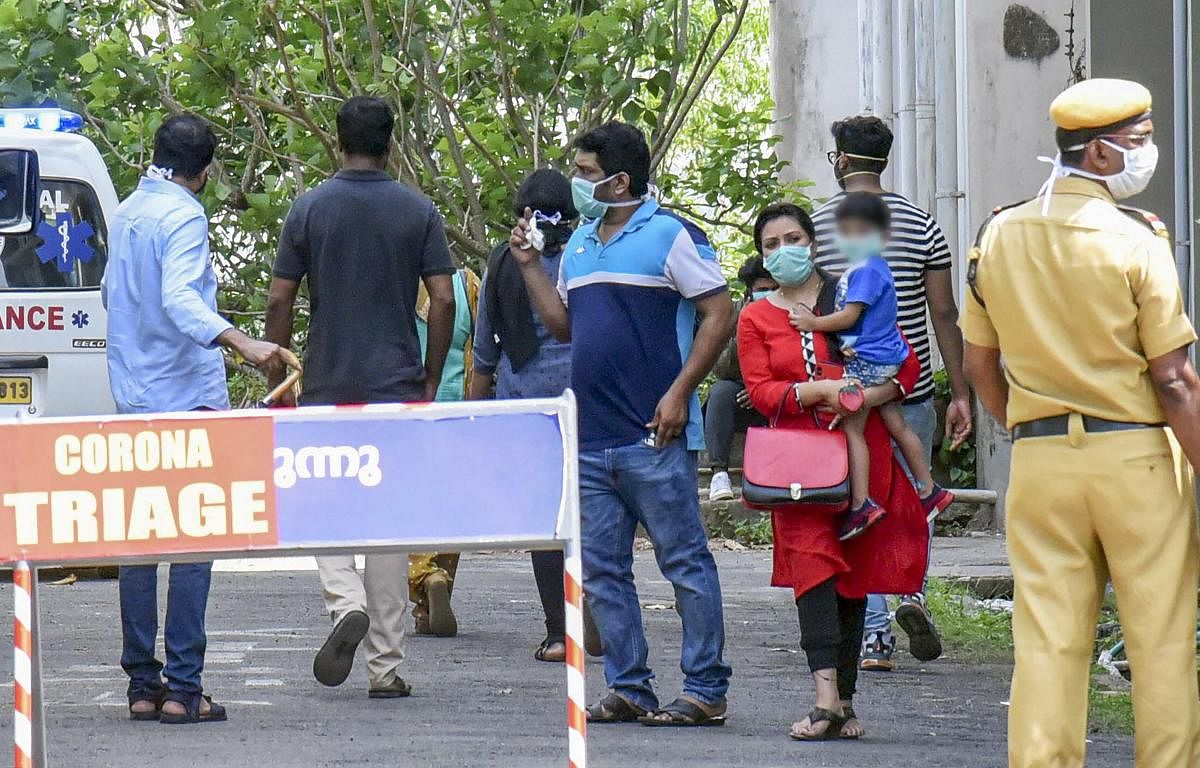 Visitors wear protective masks outside the Special Isolation Ward set up to provide treatment to novel coronavirus patients at Kochi Medical college, in Kochi, Monday, March 9, 2020. (PTI Photo)