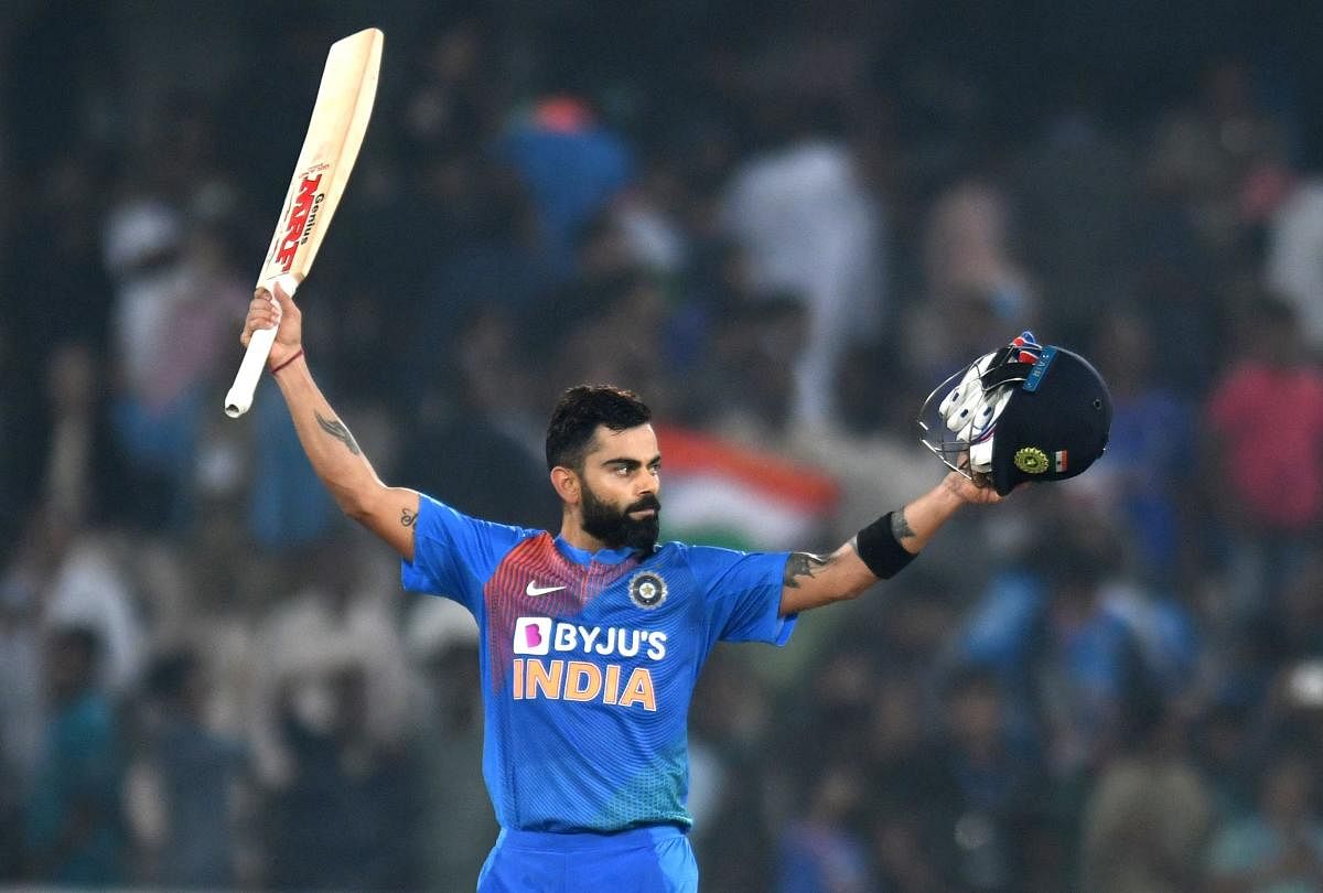 Indian cricket captain Virat Kohli raise his bat after winning the match against West Indies during the first T20 international cricket match of a three-match series between India and West Indies at the Rajiv Gandhi International Cricket Stadium in Hyderabad on December 6, 2019.  Credit: AFP Photo
