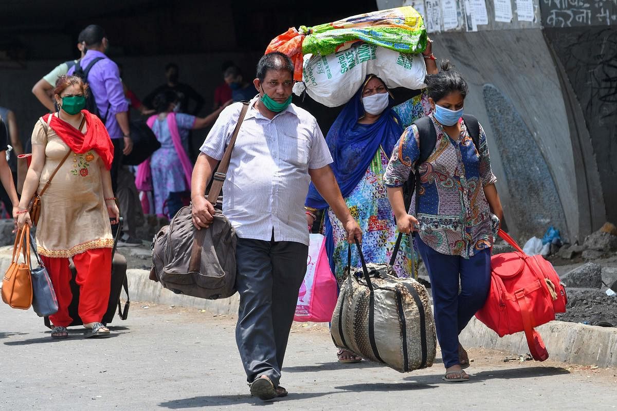 People arrive to take a special train to Himachal Pradesh outside a railway terminus during a nationwide lockdown to fight the spread of the COVID-19. AFP