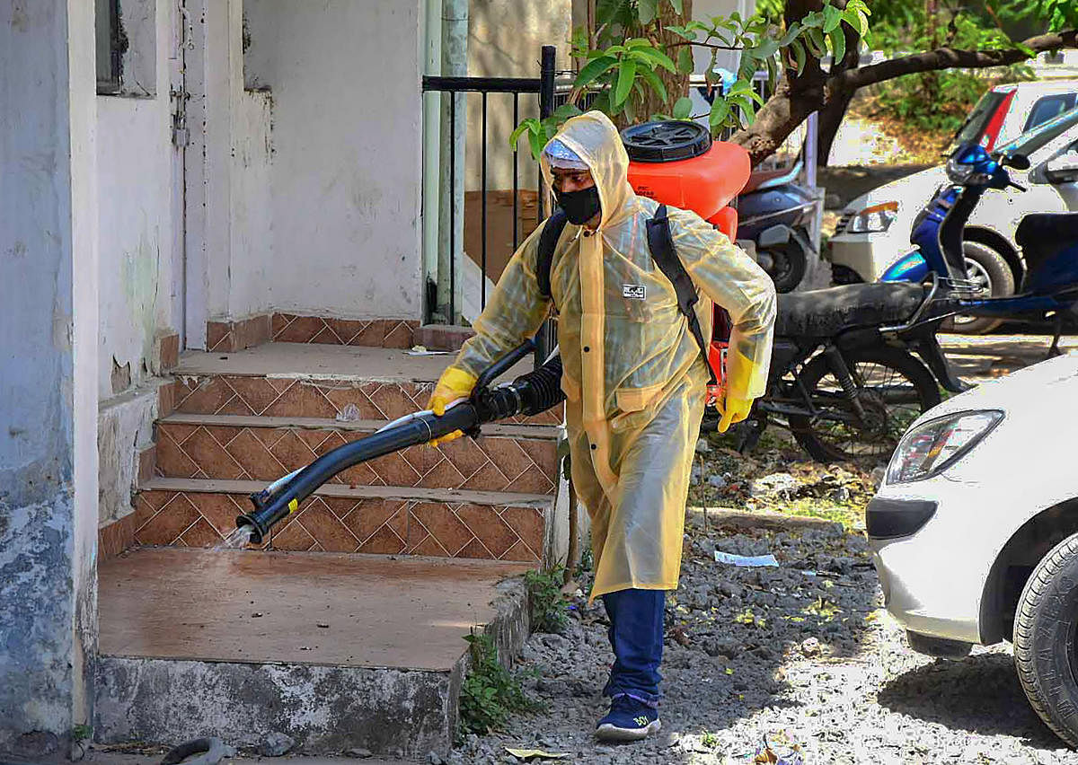  A BMC worker sprays disinfectant in the premises of a residential area to contain the spread of coronavirus during lockdown, in Bhopal, Tuesday, March 24, 2020. (PTI Photo)