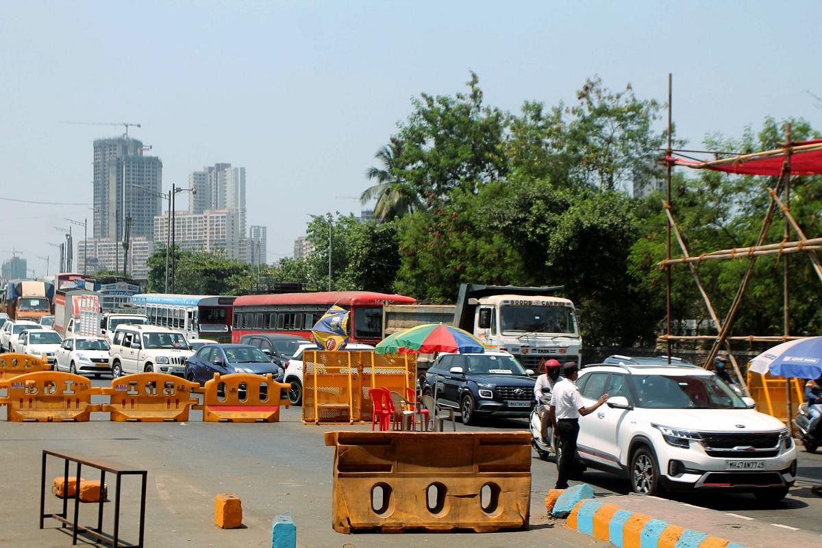 Traffic moves slowly at Dahisar Toll plaza on the Western Express Highway during the nationwide lockdown. PTI