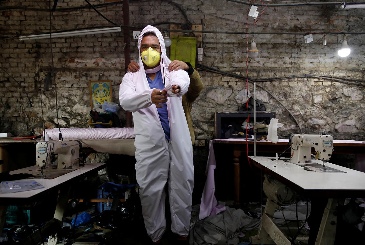 A man tries a newly made protective suit due smid COVID-19 crisis (Reuters Photo)