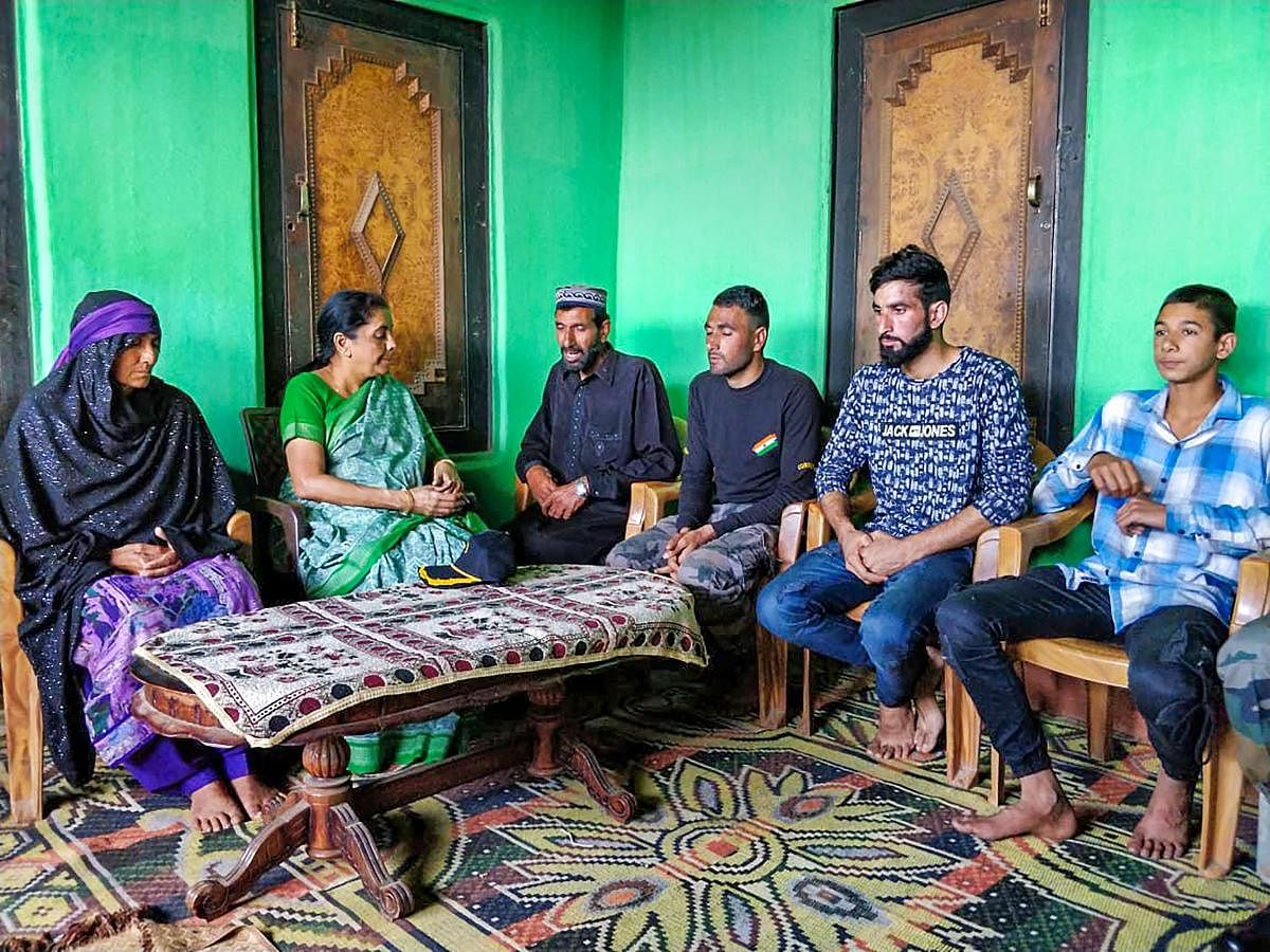 Defence Minister Nirmala Sitharaman pay condolences to rifleman Aurangzeb's family, in Poonch on Wednesday, June 20, 2018. Aurangzeb was abducted from Pulwama by terrorists and later his bullet-ridden body was recovered on June 14. (@DefenceMinIndia Twitter Photo via PTI)
