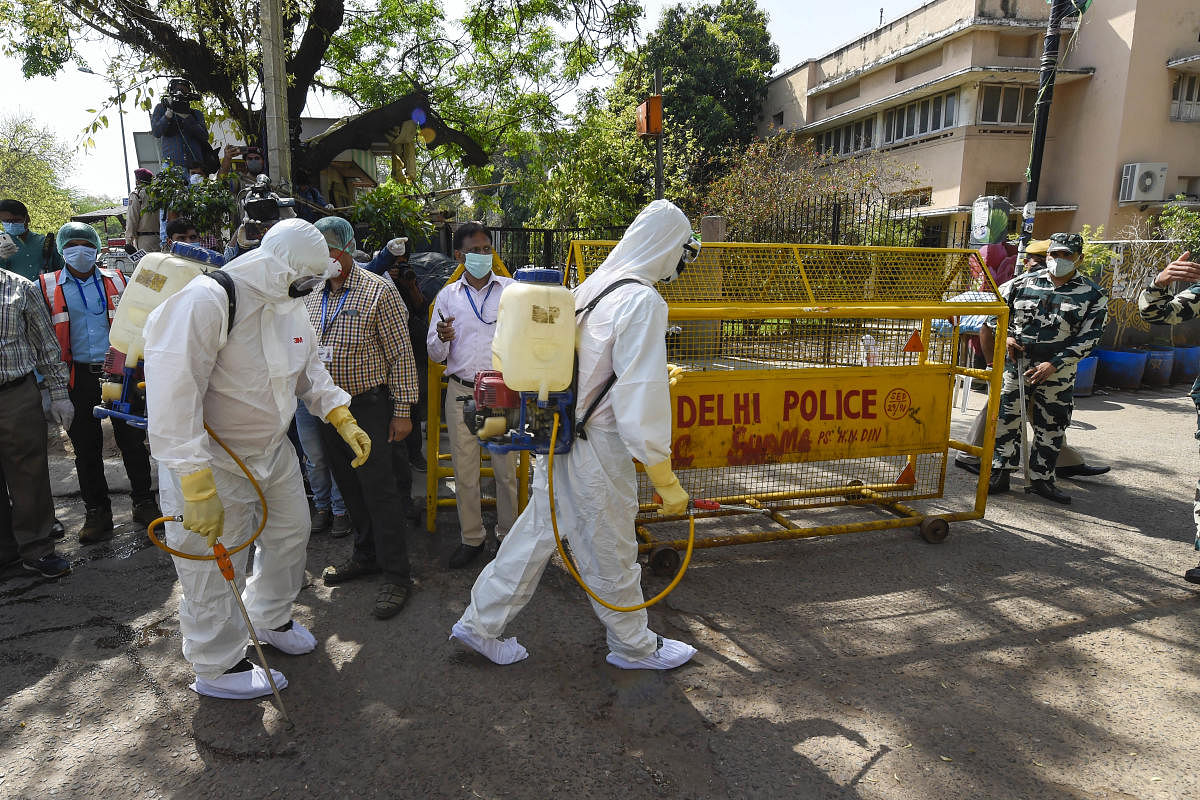  Health workers prepare to sanitise an area near Nizamuddin mosque, after people who attended the religious congregation at Tabligh-e-Jamaat's Markaz, tested postive for COVID-19, in New Delhi, Wednesday, April 1, 2020.  Credit: PTI Photo