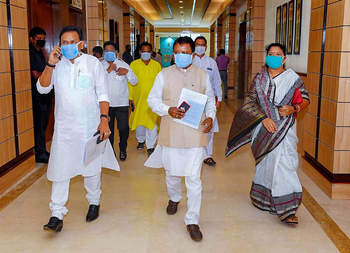  MLAs, wearing face masks, enter the State Convention Centre after proper sanitisation, during the 2nd phase of the Budget Session, amid the nationwide lockdown in the wake of coronavirus pandemic, in Bhubaneswar, Monday, March 30, 2020. (PTI Photo)