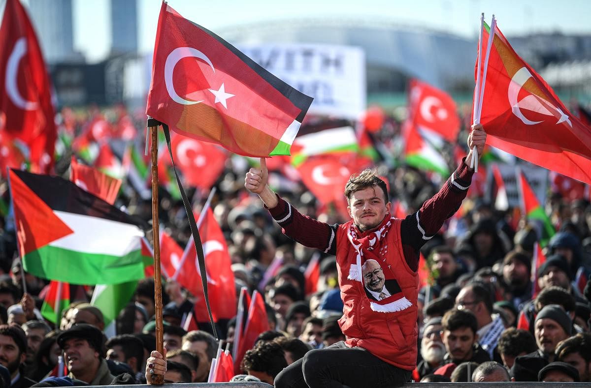 Demonstrators wave Turkish and Palestine flags during a rally at Yenikap? Square, in Istanbul, to protest against the US-made peace plan, also known as the ‘Agreement of the Century’ (Photo by Ozan KOSE / AFP)