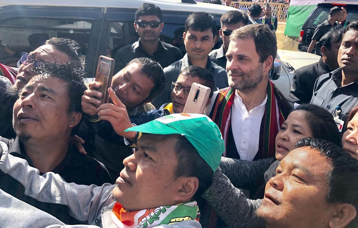 Congress President Rahul Gandhi obliges his supporters for selfies during an election rally in Champai, Mizoram. (PTI Photo)