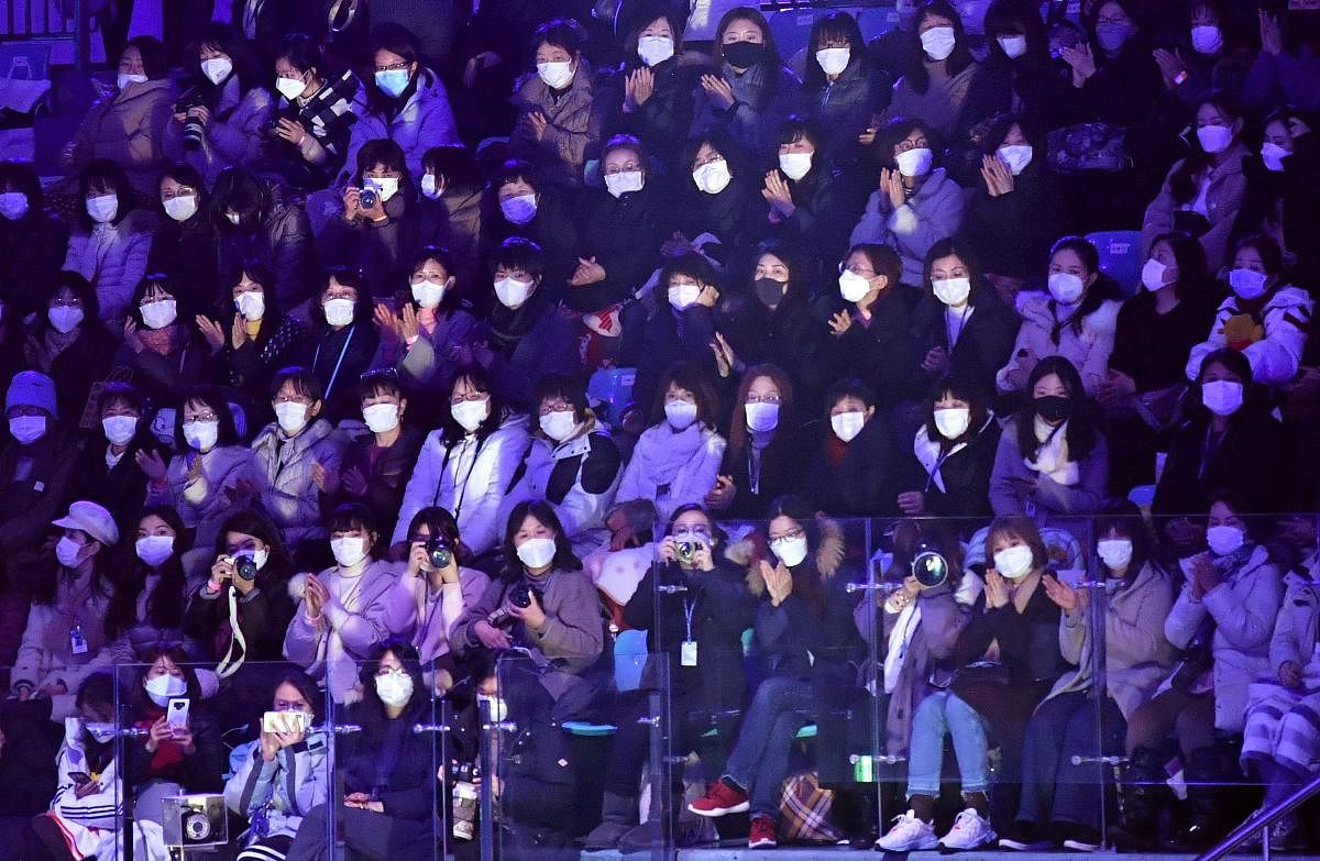 Spectators wear face masks to help prevent the spread of the SARS-like virus that originated in central China as they watch the exhibition gala at the ISU Four Continents Figure Skating Championships in Seoul on February 9, 2020. Credit: AFP Photo