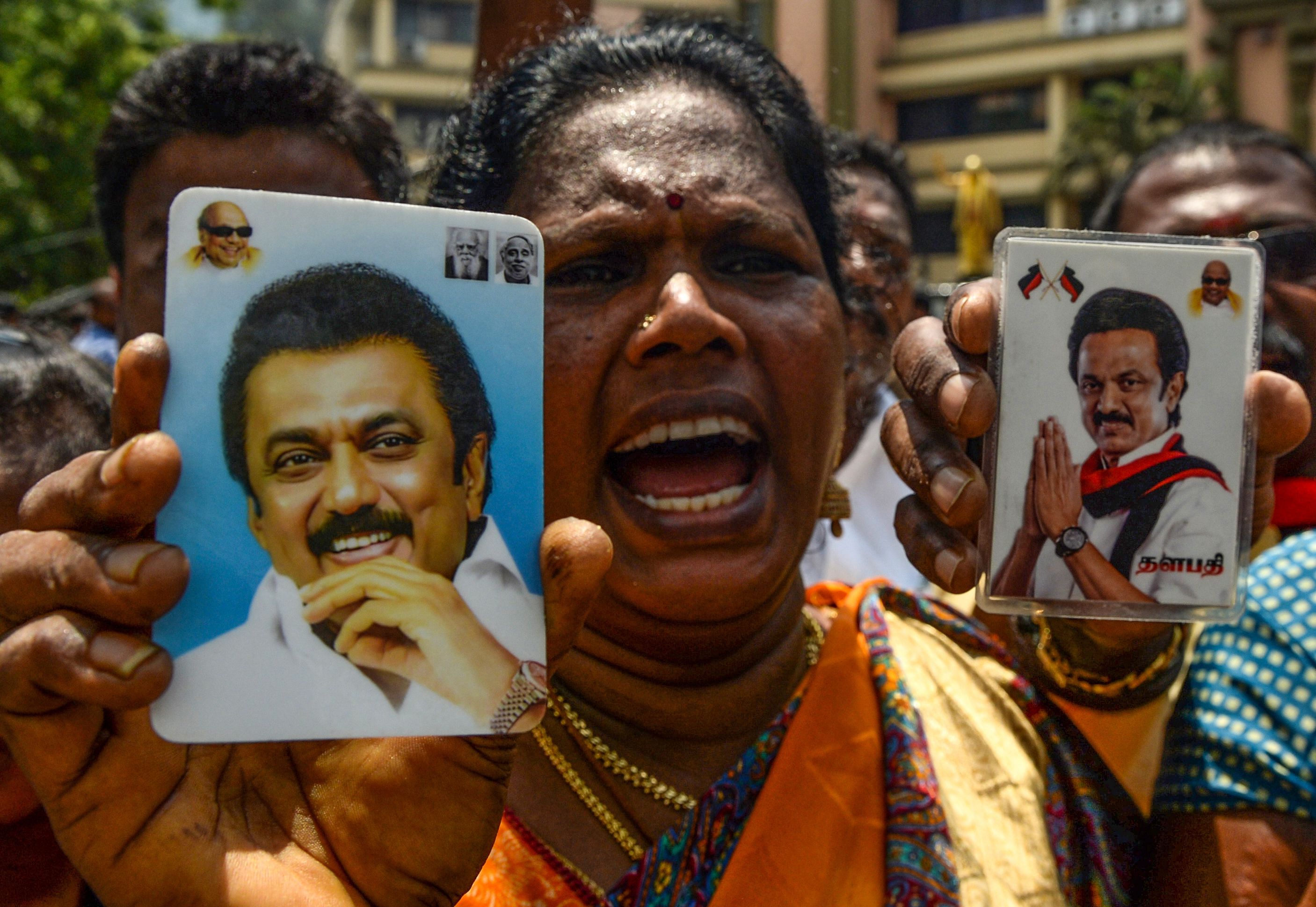 A member of the DMK shouts slogans and shows portraits of party president M.K. Stalin as she celebrates the election results in Chennai on May 23, 2019. Credit: Arun Sankar/AFP