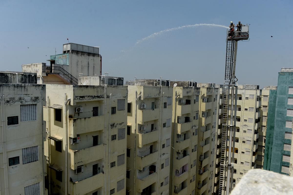 Firefighters spray disinfectant over a residential area from a sky lift crane during a government-imposed lockdown as a preventive measure against the COVID-19. AFP