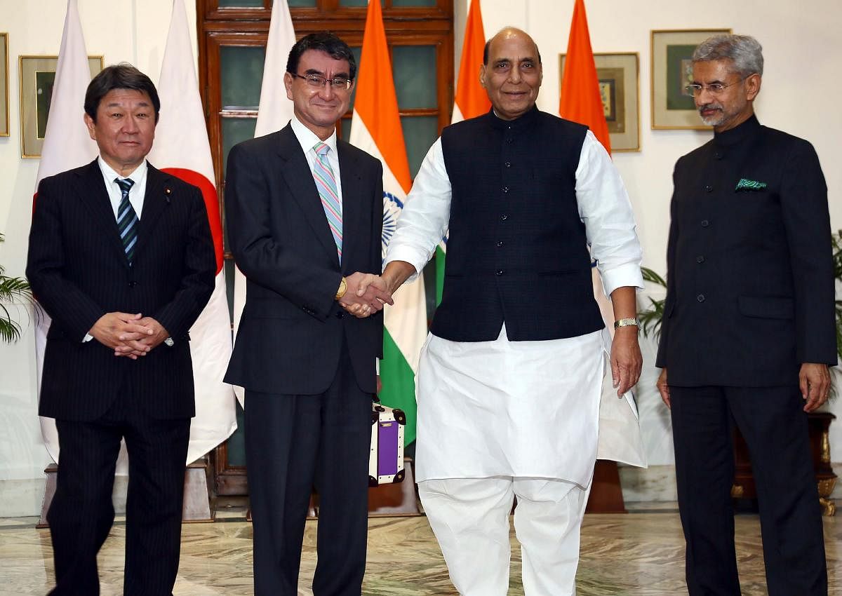 In this handout photograph taken and released by Indian Press Information Bureau on November 30, 2019, Japan's Defence Minister Taro Kono (2L) shakes hands with his Indian counterpart Rajnath Singh (2R) as India's Foreign Minister Subrahmanyam Jaishankar (R) and his Japanese counterpart Toshimitsu Motegi (L) pose during their bilateral talks in New Delhi. (Photo by Handout / PIB / AFP)