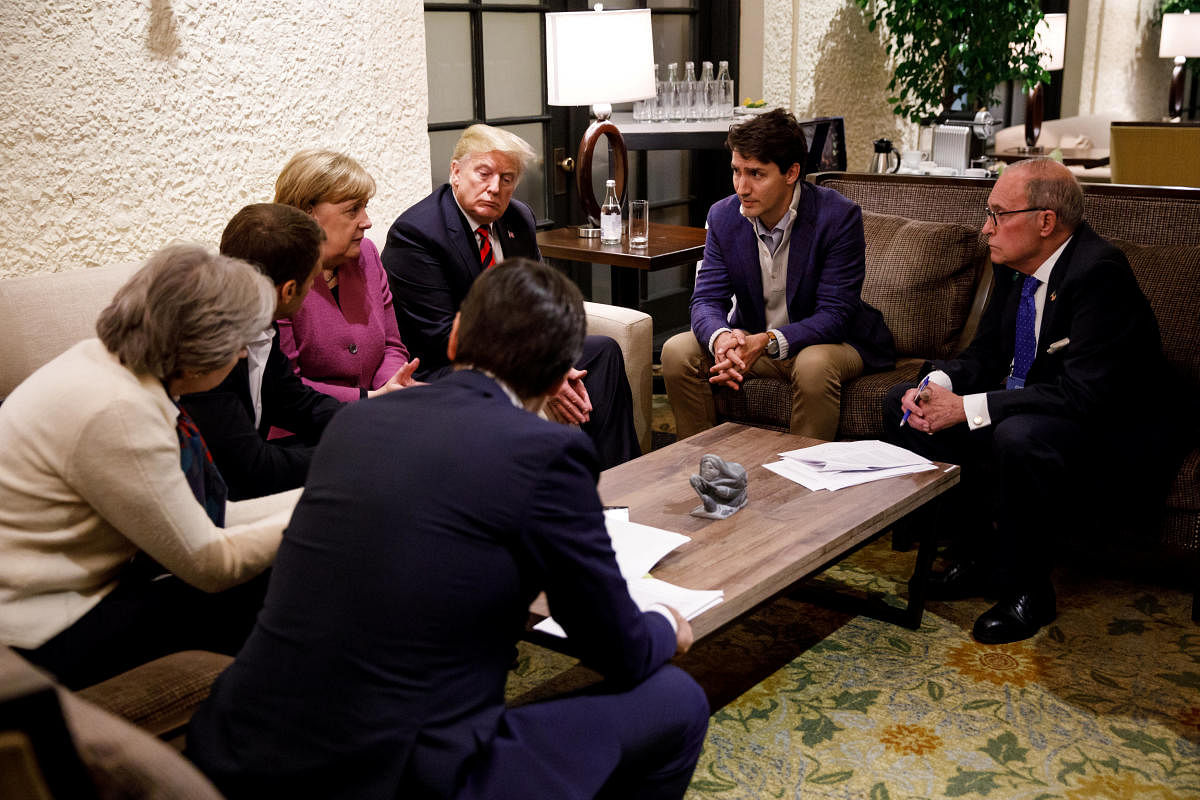 Canada's Prime Minister Justin Trudeau and G7 leaders France's President Emmanuel Macron, Germany's Chancellor Angela Merkel, Britain's Prime Minister Theresa May and U.S. President Donald Trump hold a meeting with staff on the first day of the G7 meeting in Charlevoix city of La Malbaie, Quebec. Reuters.