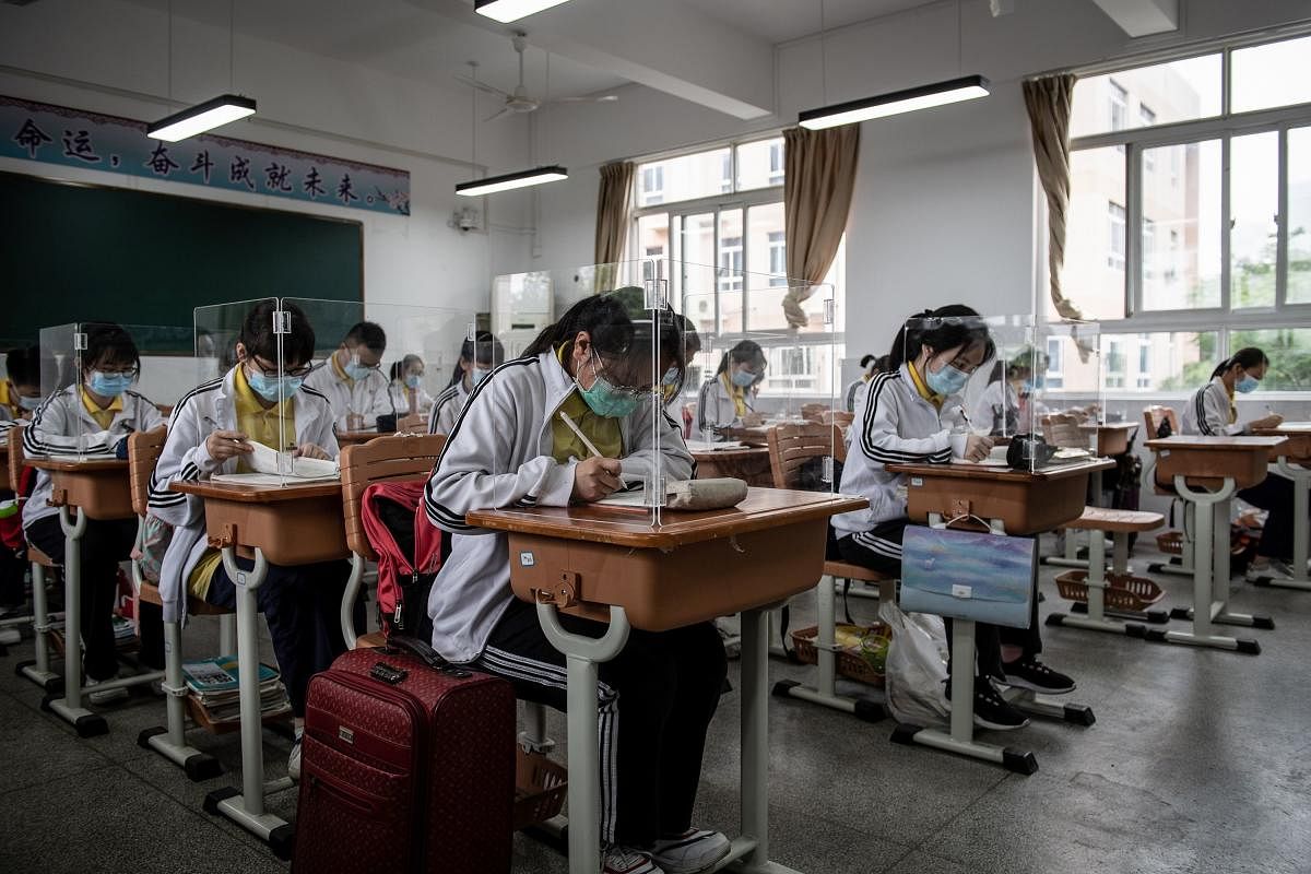High school senior students study with plastic partitions in a classroom in Wuhan in China's central Hubei province (AFP Photo)