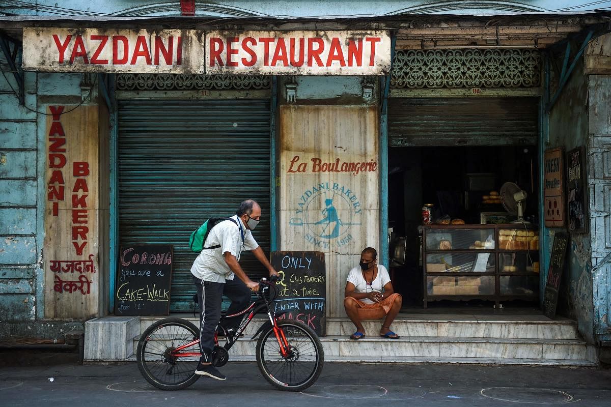 A man rides his bicycle past the Yazdani bakery, one of the city's oldest, during a government-imposed nationwide lockdown as a preventive measure against the spread of the COVID-19 coronavirus in Mumbai on April 28, 2020. Credit: AFP Photo