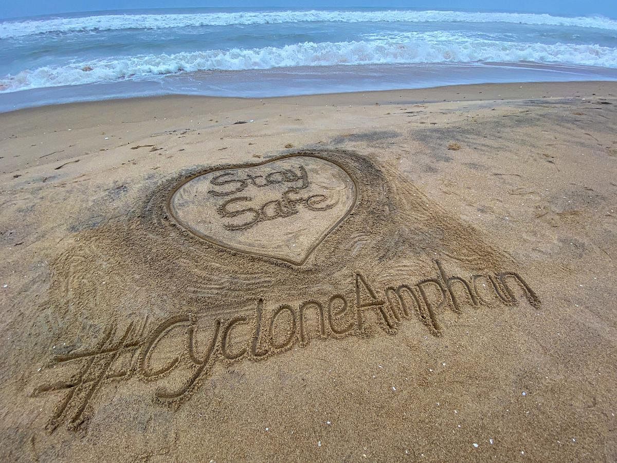 Sand artist Sudarsan Pattnaik created a sand art on cyclone Amphan at Puri beach, Tuesday, May 19, 2020. (PTI Photo)