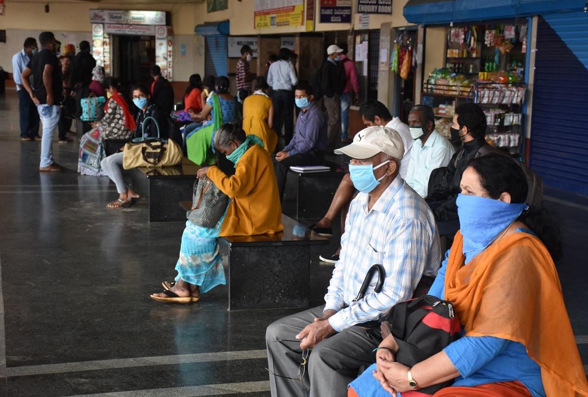 Passengers wait for buses at the KSRTC Bus Stand in Madikeri. DH photo