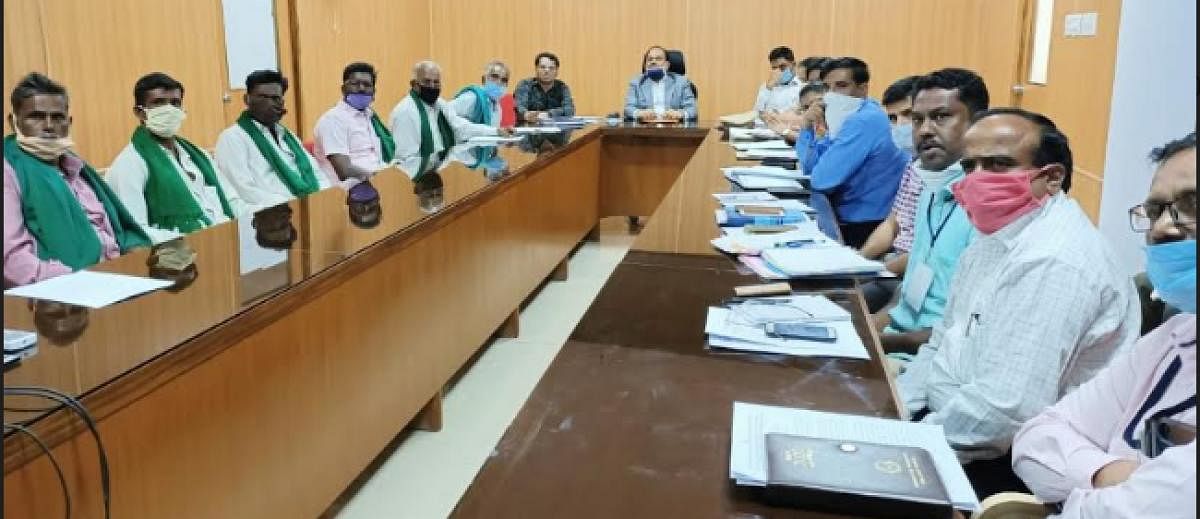 Deputy Commissioner M R Ravi chairs the meeting of District Level Rehabilitation Committee at Chamarajanagar on Wednesday. Deputy Conservator of Forests V Yedukondalu is seen. DH PHOTO