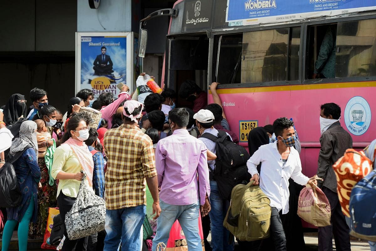 Passengers gather to board inside a bus as Telangana State Road Transport Corporation (TSRTC) resumed bus services after the government eased a nationwide lockdown imposed as a preventive measure against the COVID-19 coronavirus. AFP