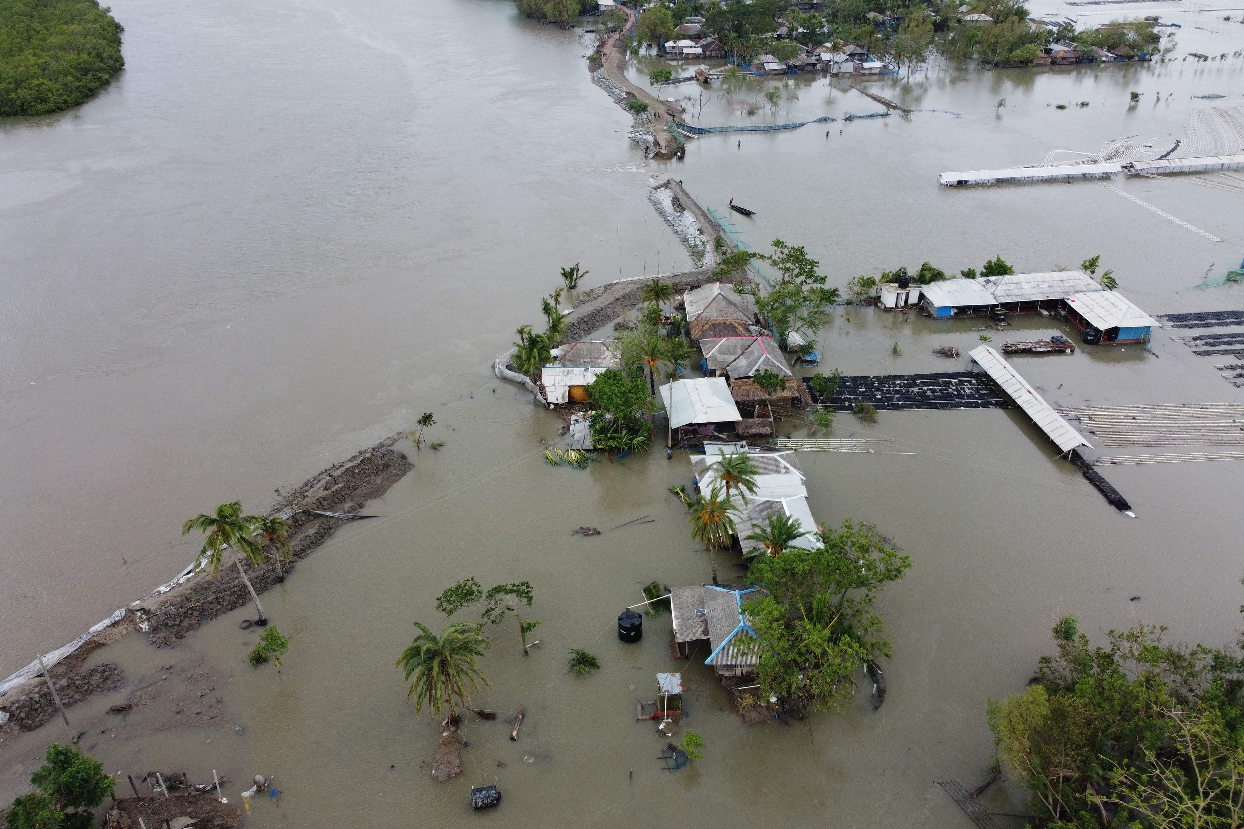 An aerial view shows flooded houses and buildings after a dam broke following the landfall of cyclone Amphan in Shyamnagar on May 21 (AFP photo)