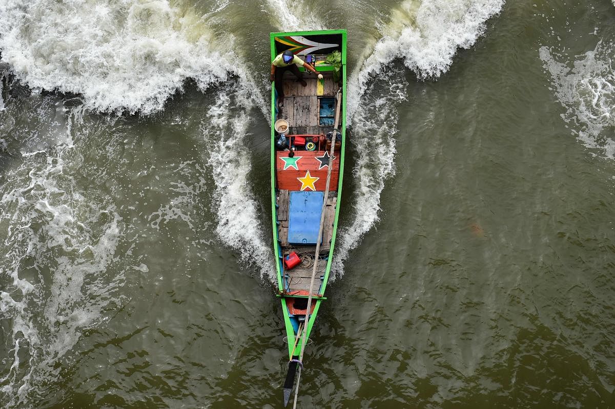 A fisherman rides a boat back to a beach in Banda Aceh in Indonesia. (AFP Photo)