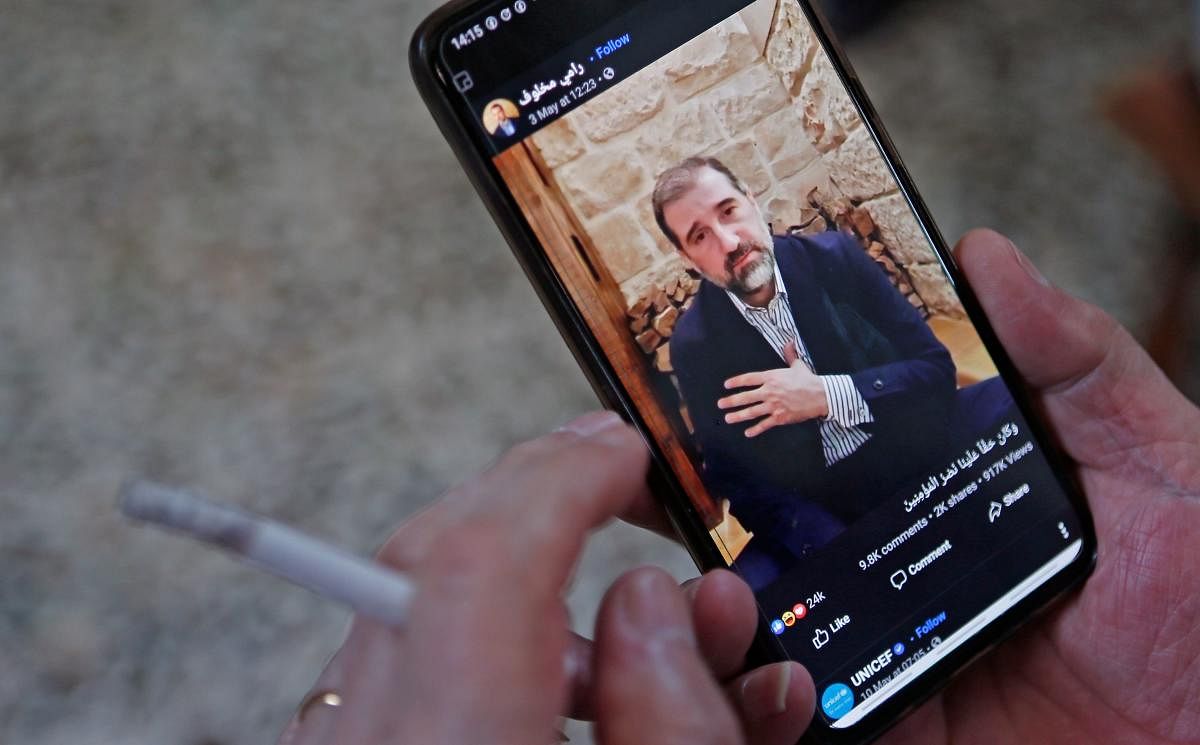  A man watches the Facebook video of Syrian businessman Rami Makhlouf on his mobile in Syria's capital Damascus, on May 11, 2020. Credit: AFP Photo